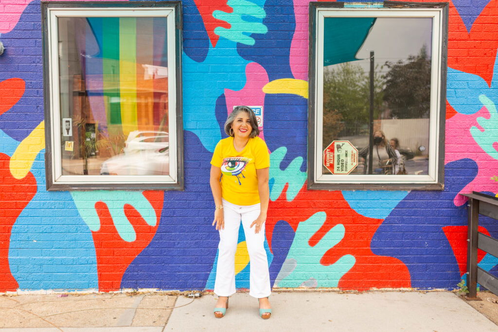 Dr. Safavi in front of graffiti wall