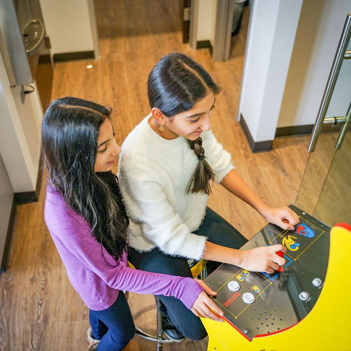 Patients Playing Games In Dental Office Lobby