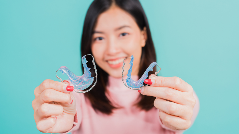 Woman holding her retainers