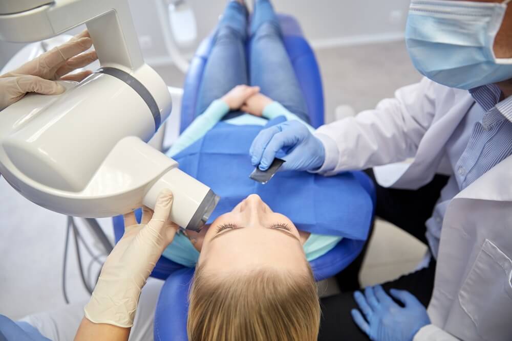 Patient taking intraoral x-ray