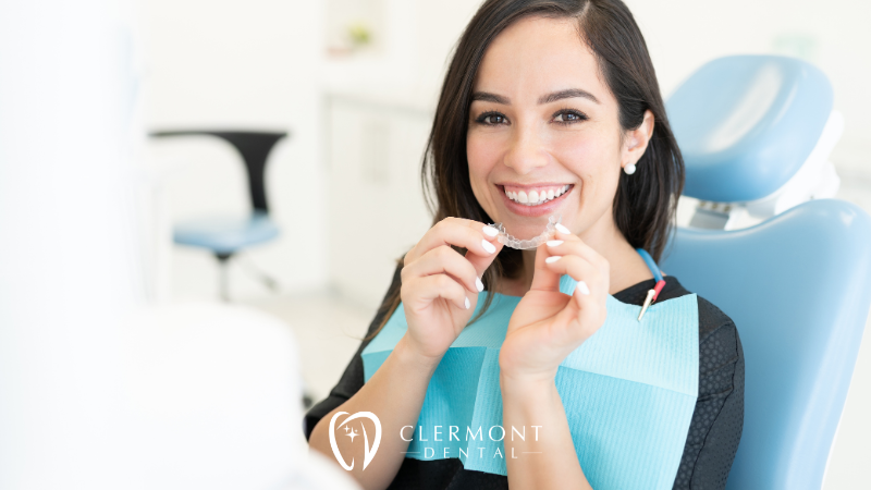 Woman in dental chair wearing clear aligners