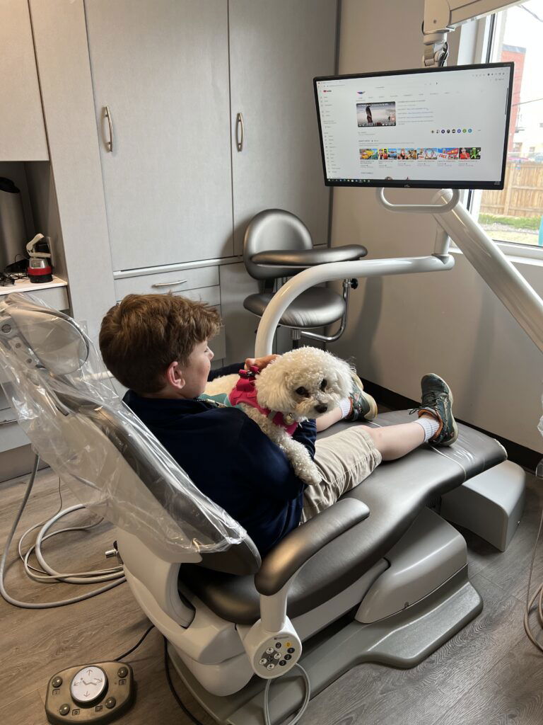 Clermont Dental patient with our emotional support dog Hoolu