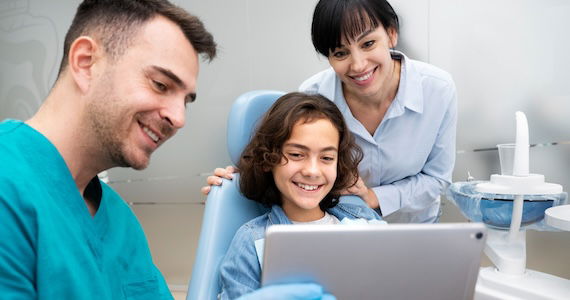 doctor discussing with young patient and parent